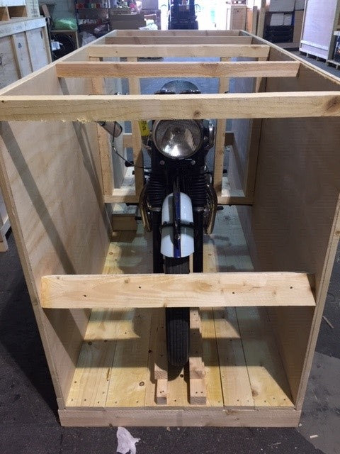 Classic bike getting put into a crate ready for international shipping